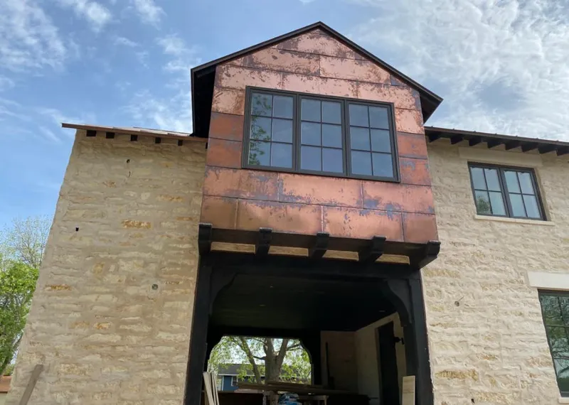 Copper metal panel facade on a stone building for Roof Repair in Firebaugh
